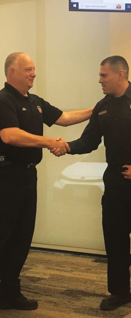 Chief Trent Harwig swears in Justin Salinas as a driver_operator.