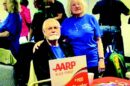 A man and woman posing for a photo at an aarp event in Falcon Colorado