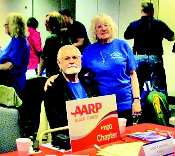 A man and woman posing for a photo at an aarp event in Falcon Colorado