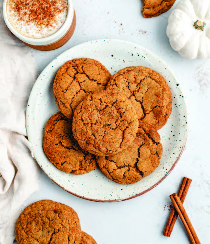 Ginger cookies on a plate with a cup of coffee.