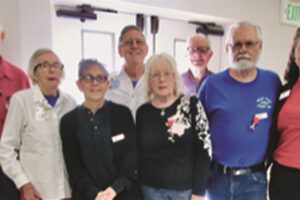 A group of older people posing for a photo