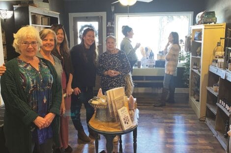 Group of people gathered inside a cozy boutique shop.