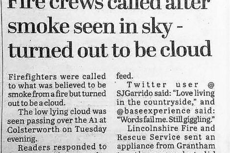 Newspaper clipping reporting that a perceived fire with smoke turned out to be just a cloud.