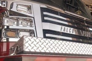 Front grille and headlights of a falcon fire department truck.
