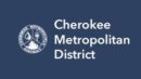 Logo of Cherokee Metropolitan District with an emblem representing water, a tree, and a gear, alongside the text "Cherokee Metropolitan District" on a navy blue background.