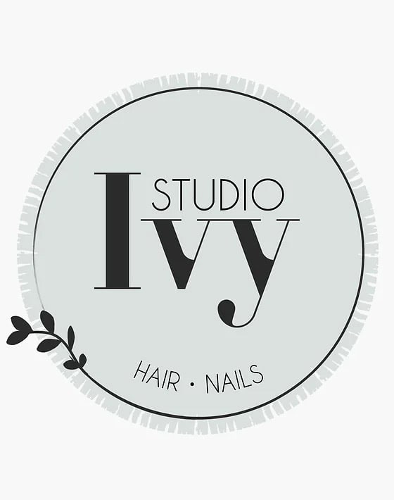 A round, light green logo with "Studio Ivy" in large text and "Hair • Nails" in smaller text at the bottom, featuring a small branch graphic.