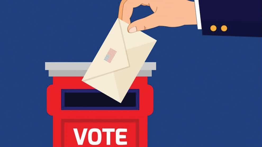 A hand is shown placing an envelope into a red ballot box labeled "VOTE" against a blue background.