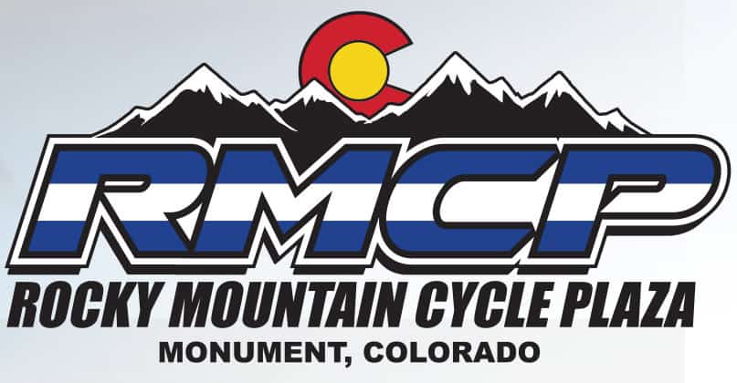 Logo of Rocky Mountain Cycle Plaza featuring snow-capped mountains and the Colorado state flag symbol, with text: "Rocky Mountain Cycle Plaza, Monument, Colorado.