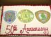 Rectangular cake with three fire department logos and "50th Anniversary" written in red icing.